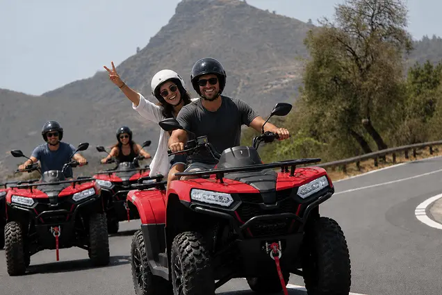 Riders on a three-hour quad bike safari through Teide National Park in Tenerife, surrounded by volcanic scenery.