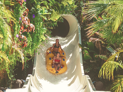Guests riding a water slide at Siam Park Tenerife in Costa Adeje