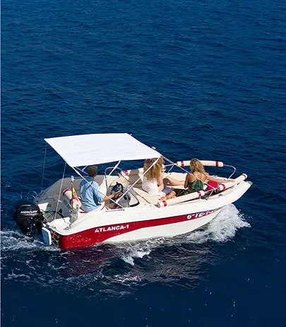 A self-drive hire boat cruising the coast of Tenerife from Puerto Colón.