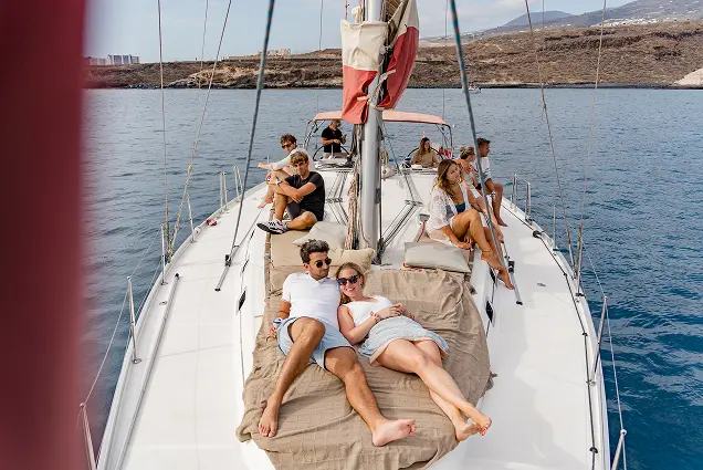 Guests relaxing on the deck of the Atlantic Star yacht during a sailing excursion in Tenerife.