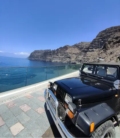 A Jeep in Teide's volcanic landscape at sunset during a guided tour in Tenerife.