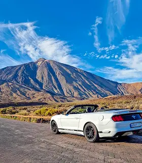 A Ford Mustang on a mountain road at sunset during a Teide tour in Tenerife.